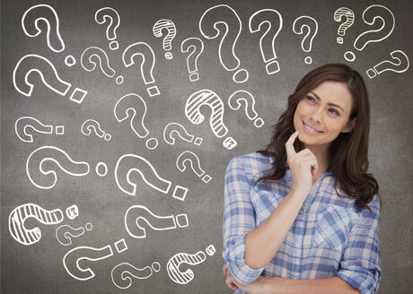 young woman thinking with question marks surrounding her