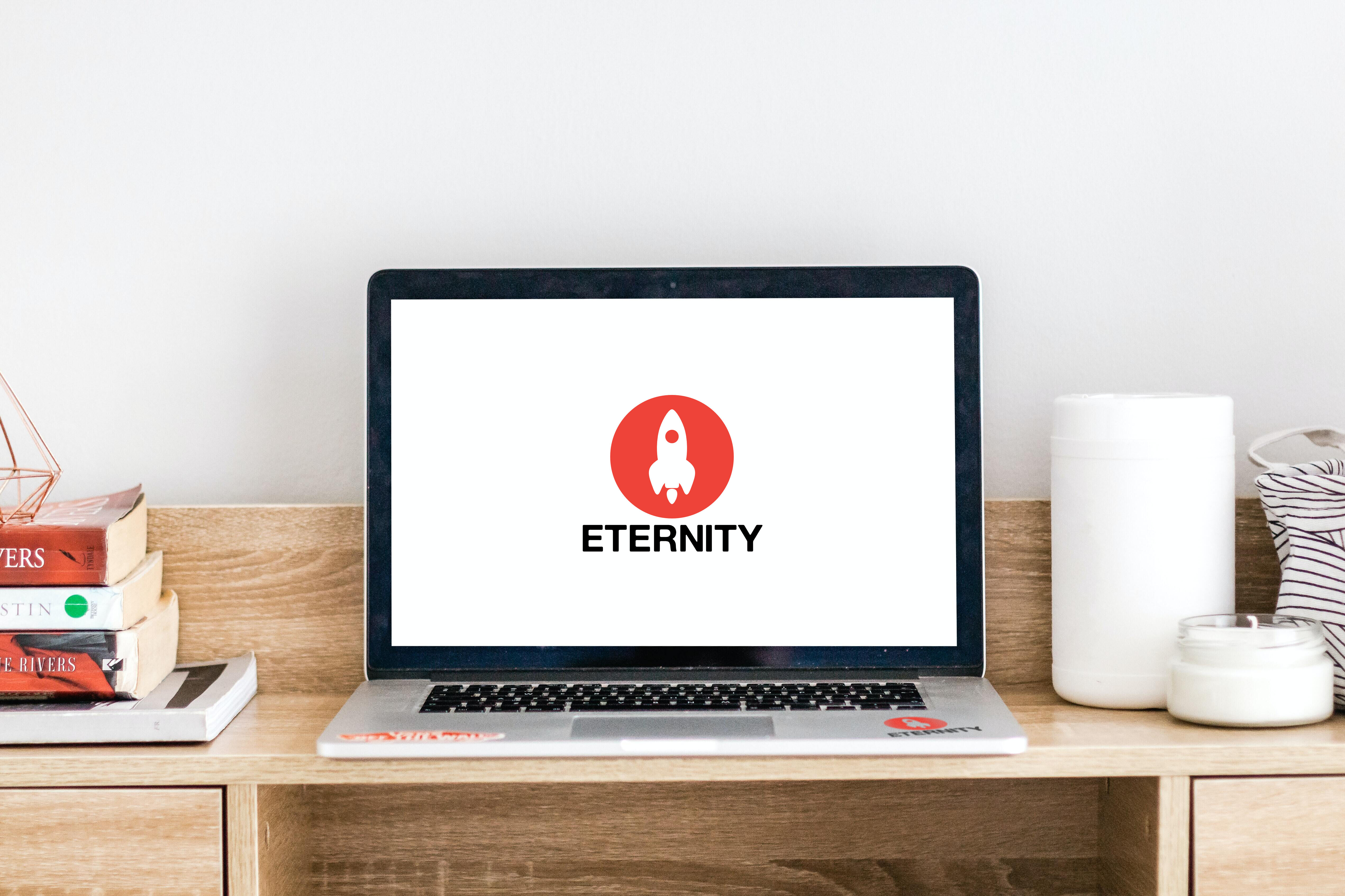 Eternity logo on laptop screen on desk