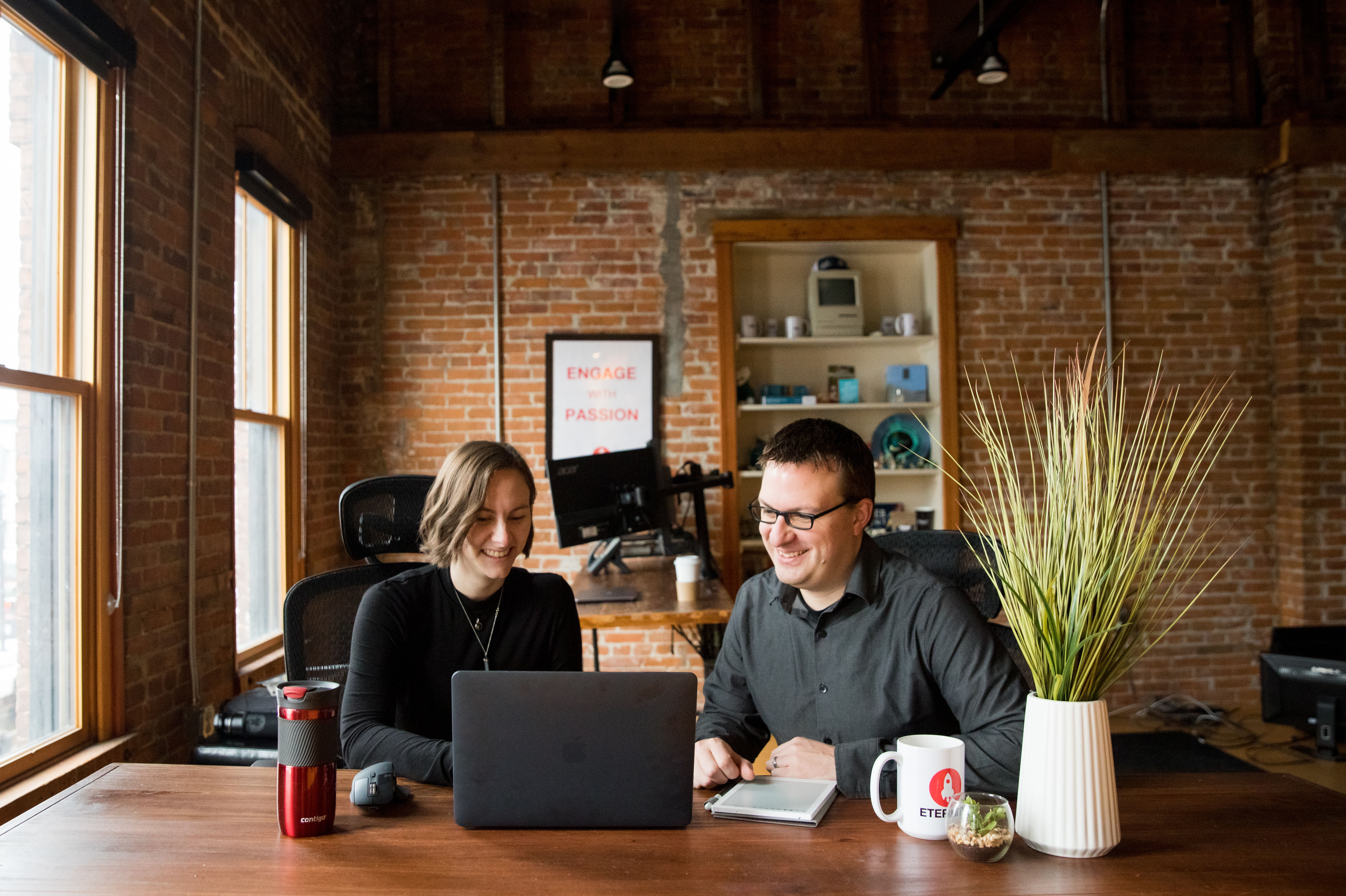 Shawna and Mike working together on a laptop in the Eternity headquarters