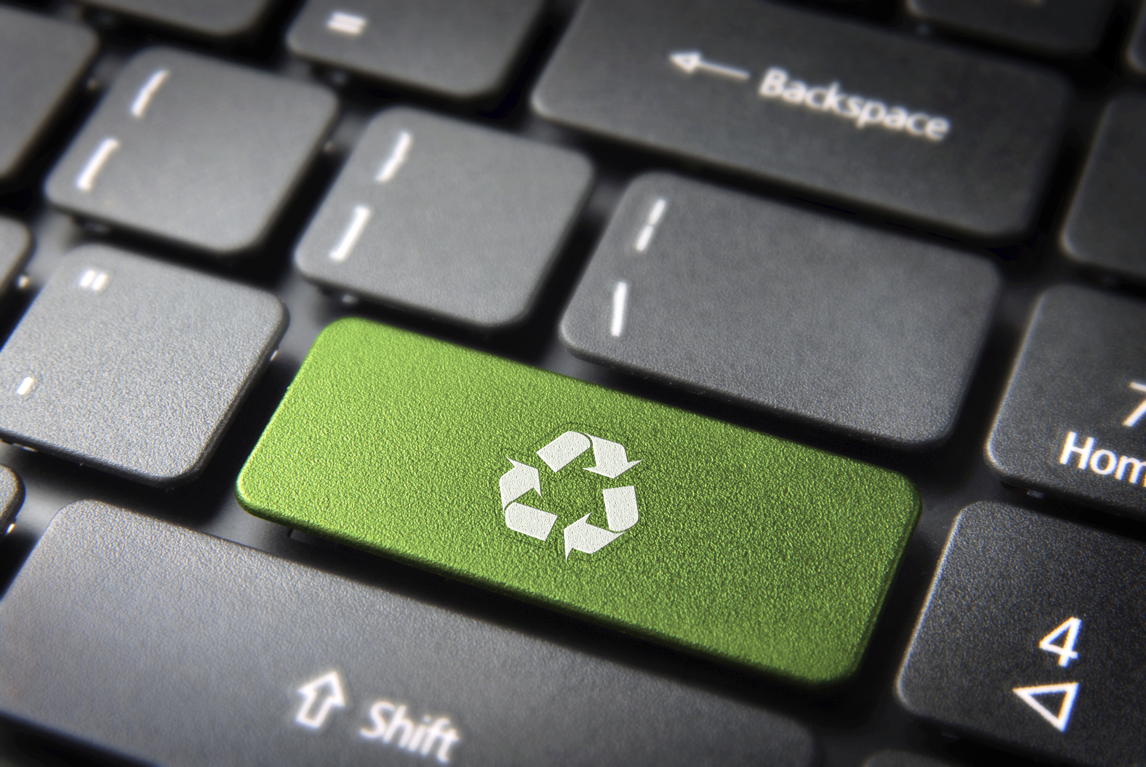 Green recycle button on computer keyboard