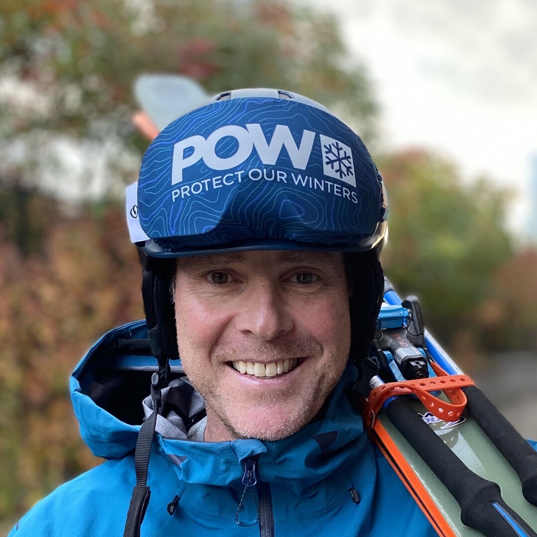 Smiling person in a blue jacket and helmet promoting "Protect Our Winters."