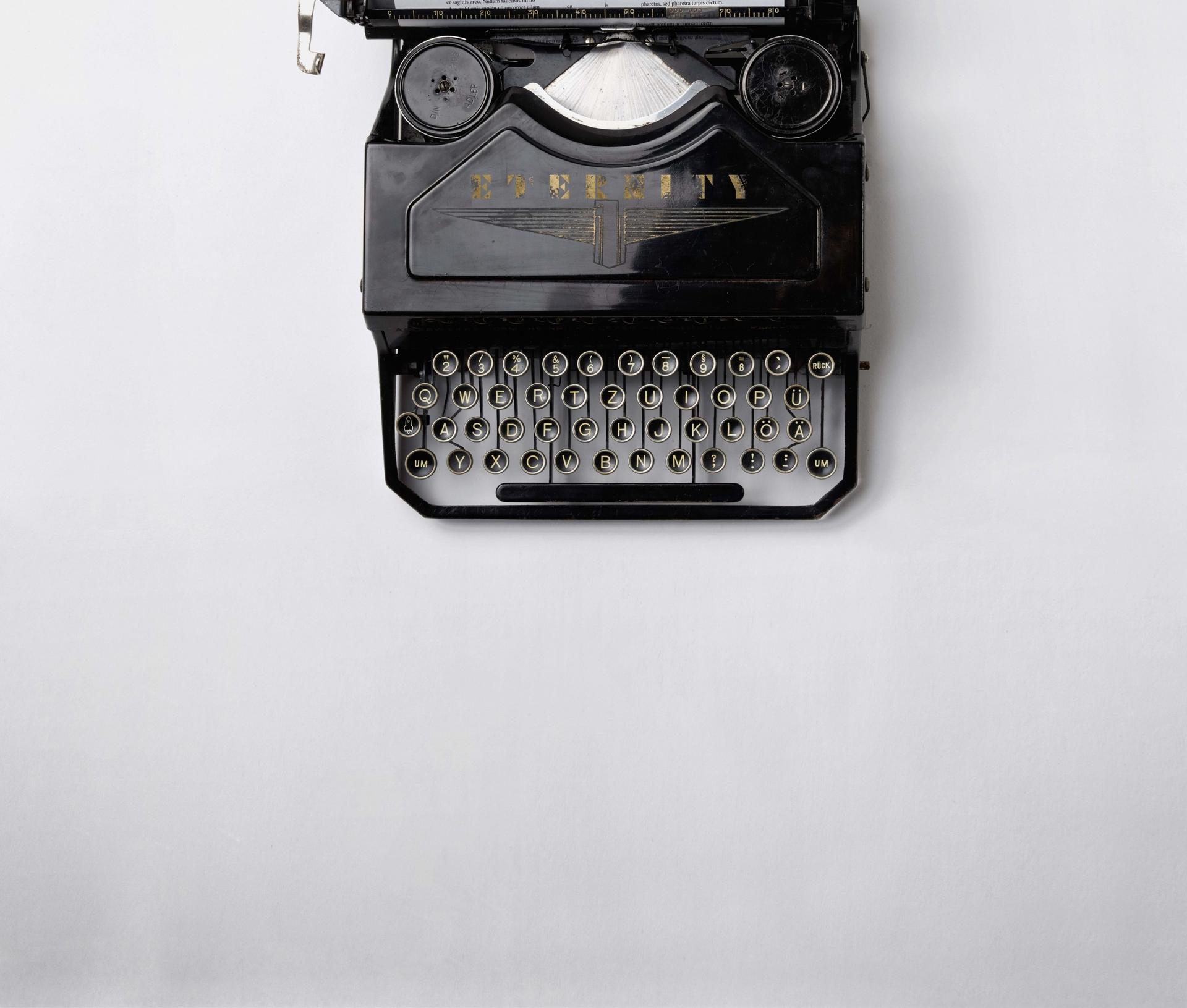 Typewriter with Eternity logo