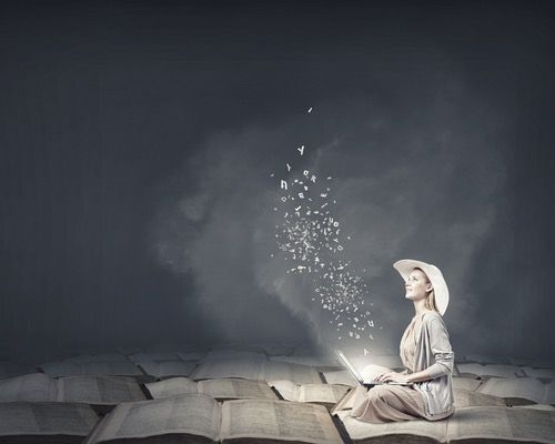 Woman in a hat sitting on books, typing with floating letters around her