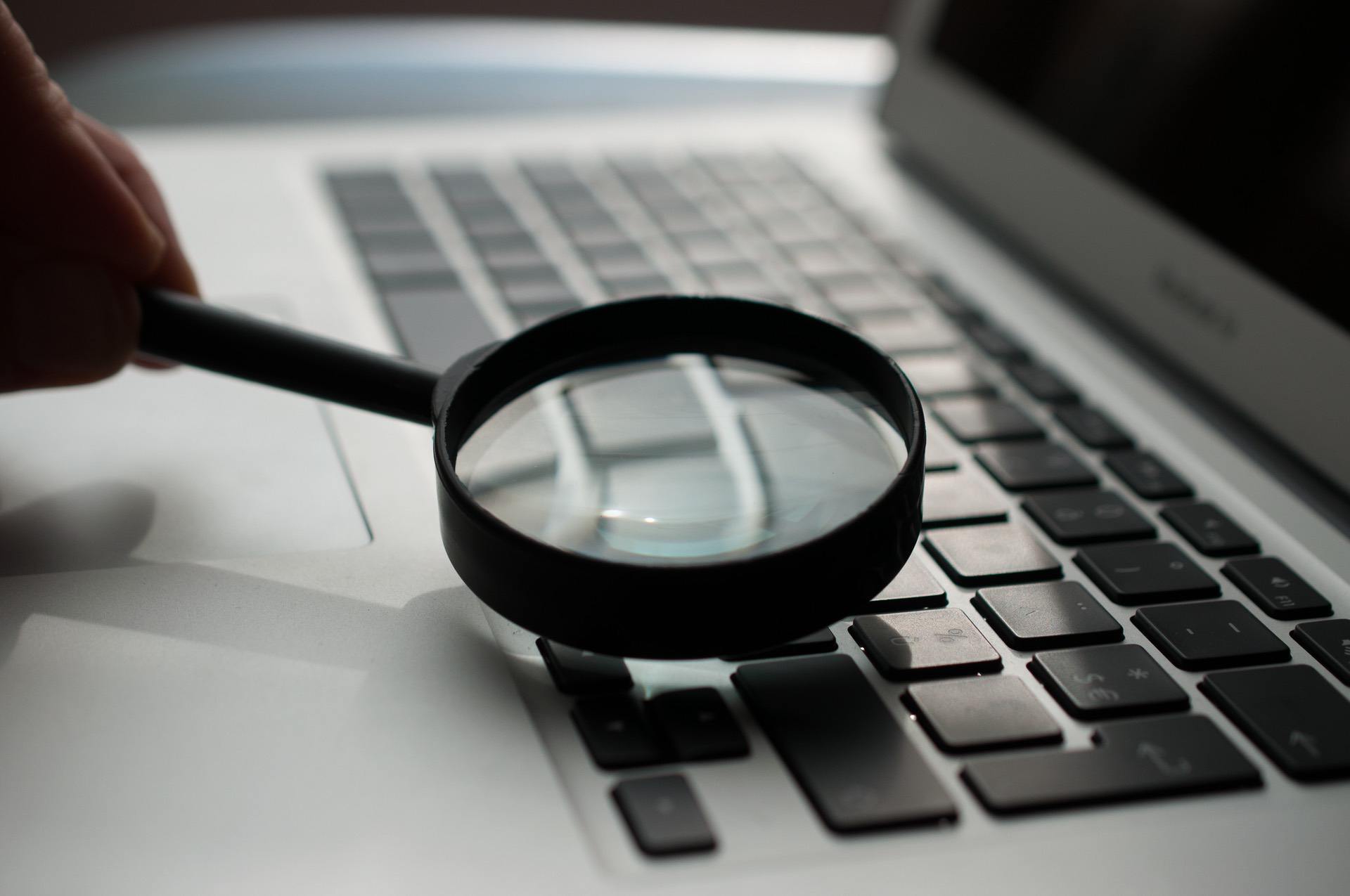 Magnifying glass held against a keyboard