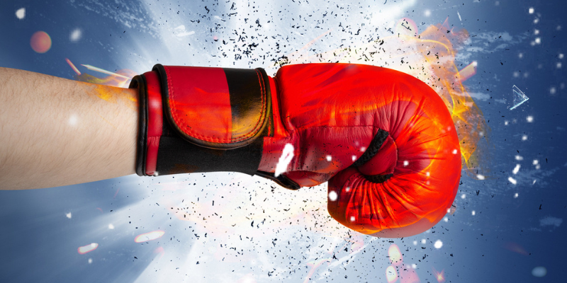 Boxing glove punching forward, creating a explosion resembling fireworks.