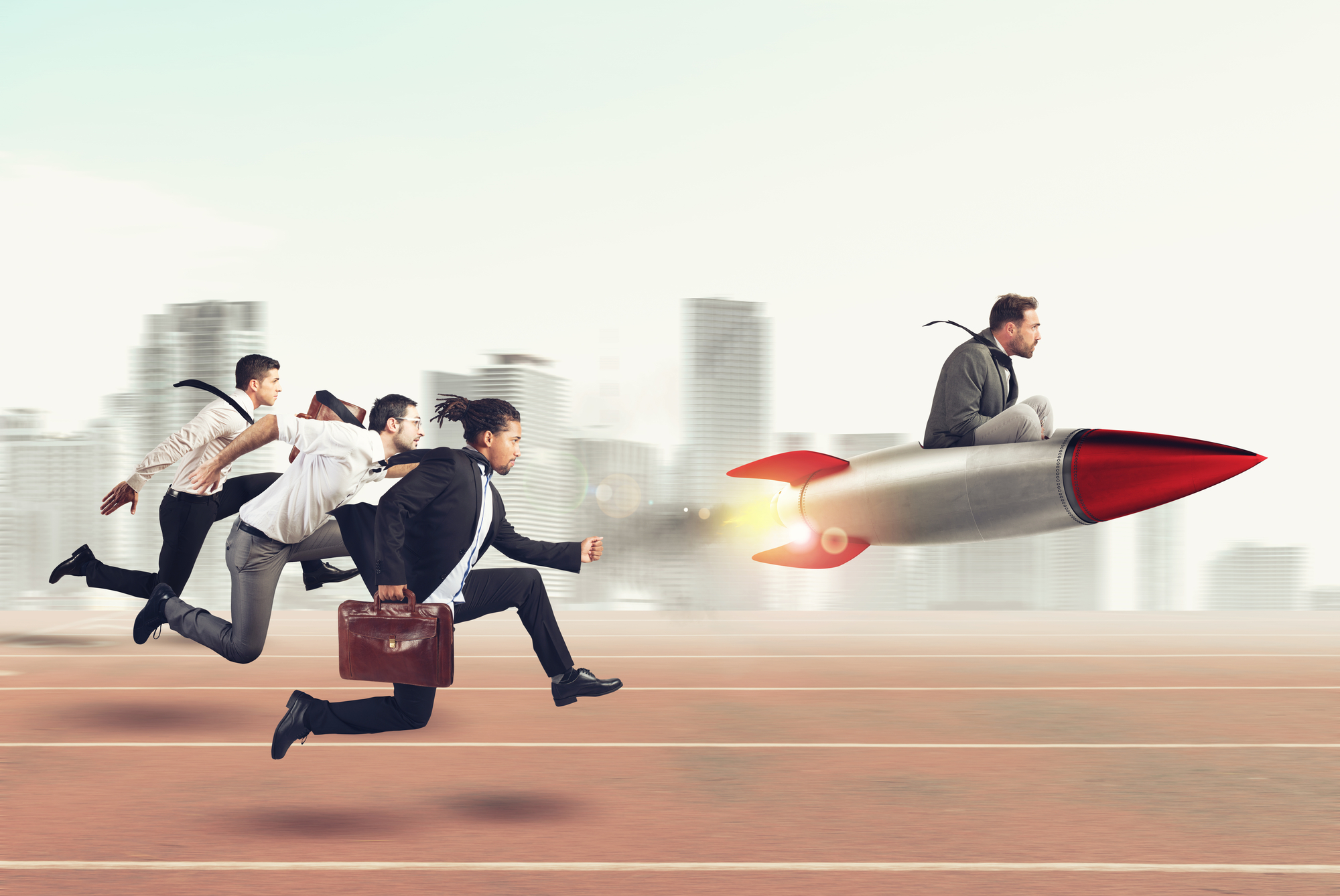 Businessman on rocket, three competitors chasing behind on a racetrack.