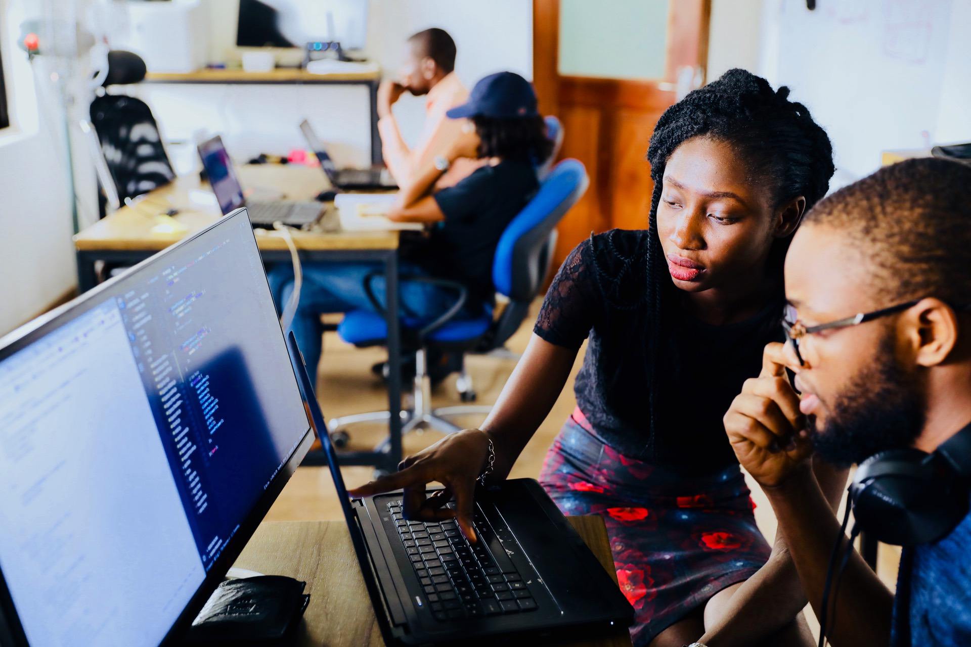 Two people looking at a computer and learning