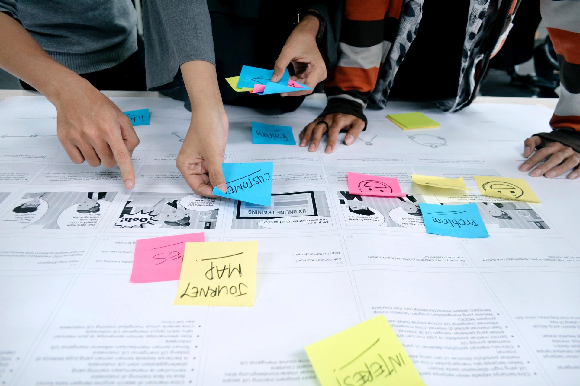 A group of people are working on design layout
