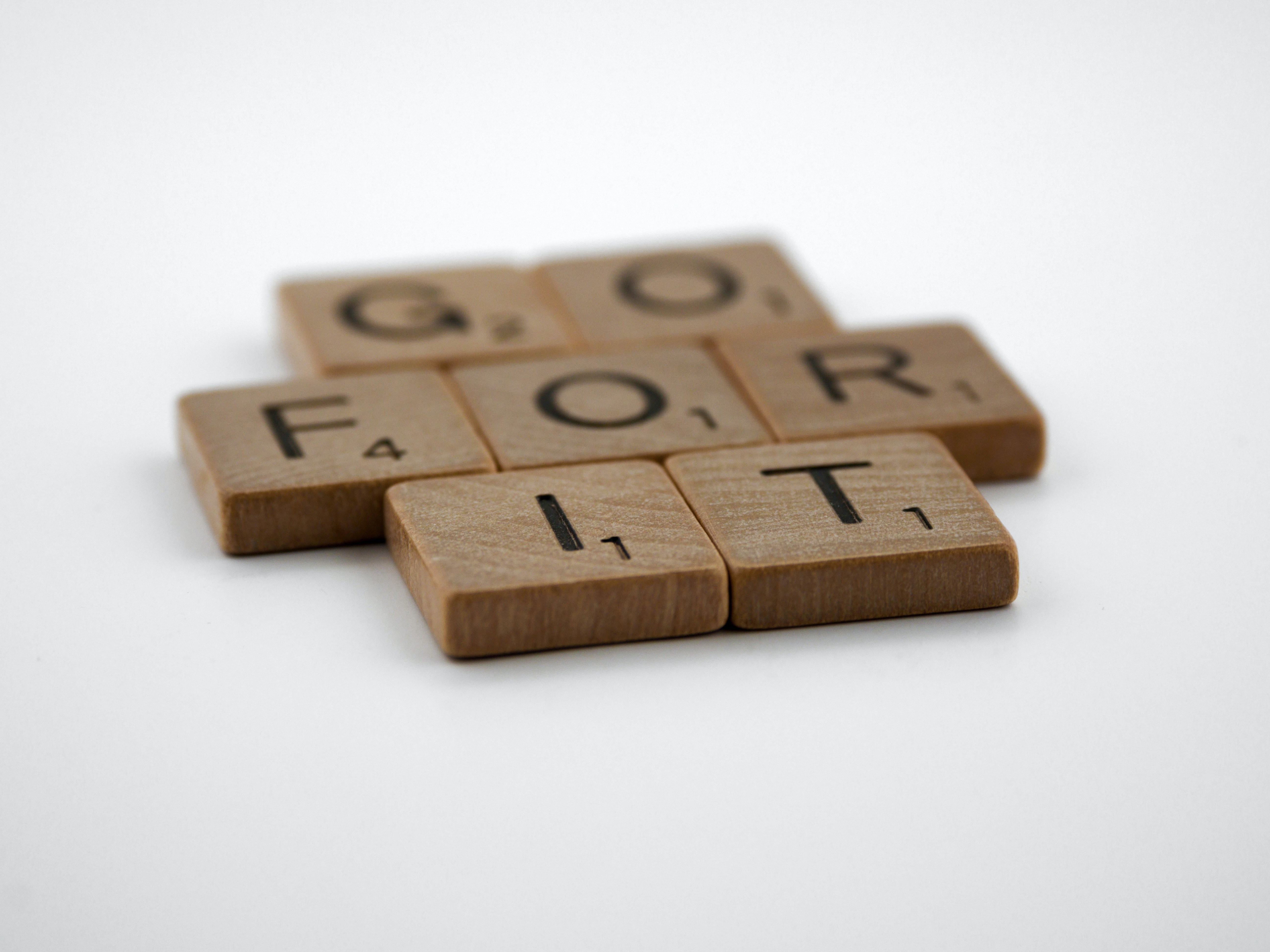 Scrabble pieces that spell "Go for it."