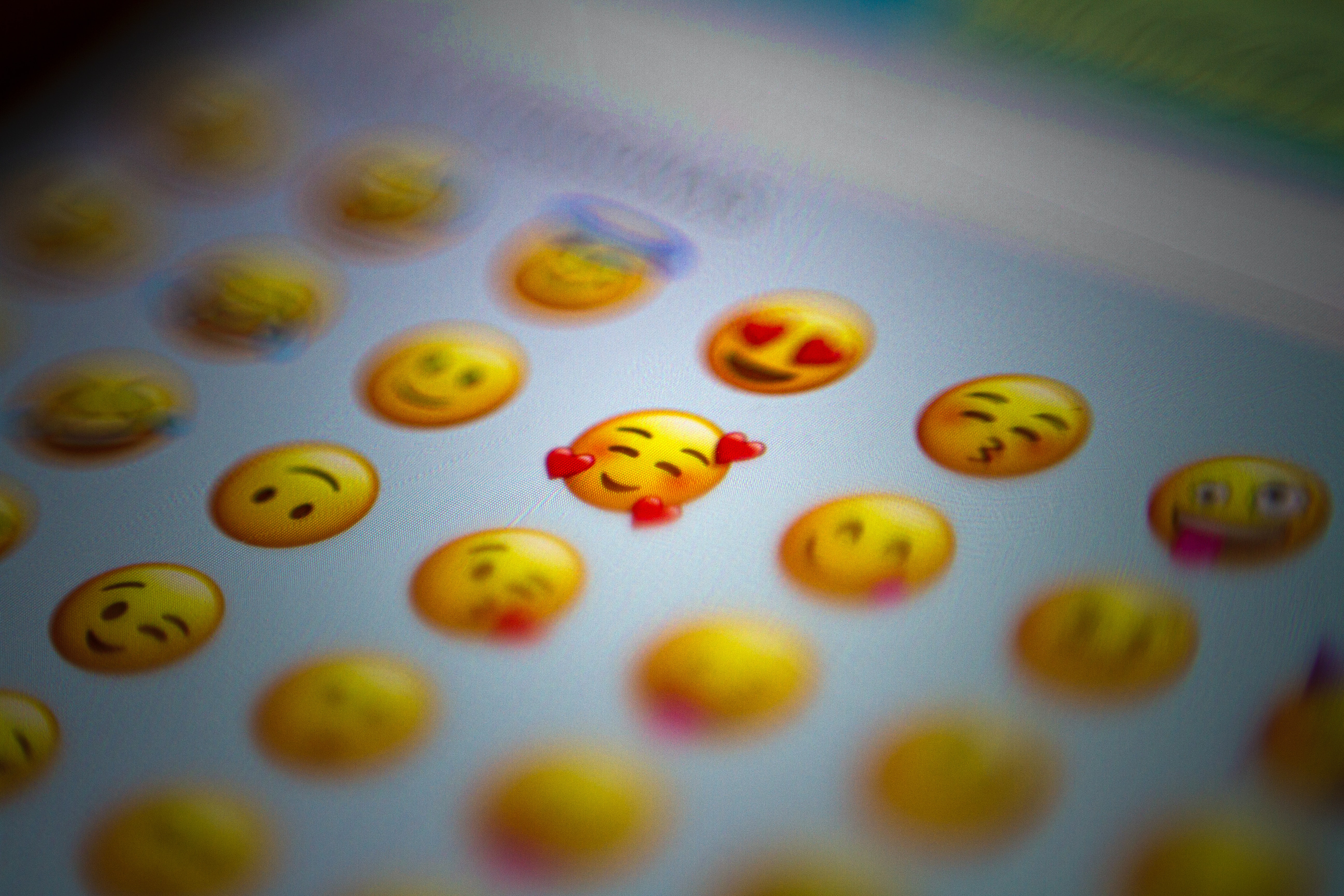 A phone screen highlighting the heart-face emoji